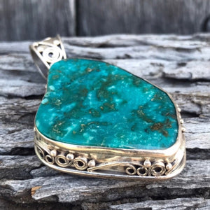 This dazzling large Navajo Pendant measures.  Beautiful handmade pure silver setting surrounds the natural Lone Mountain Turquoise! Unique lucid blue stone colour.  Handmade in New Mexico by Artisan. The large detailed bail is perfect for Navajo Pearls, leather cord or chunky silver necklace. Sold as pendant without necklace.