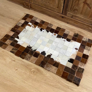 Genuine cowhide patchwork mat. Nice and thick with backing perfect for your ranch house entry or mud room.  Approx size 50x80cm. Heavy Duty. Handcrafted.  Grown on a real cows by real cowboys, this plush mat is an ethically sourced by-product of the food industry. Try arguing polyester is better for the environment.