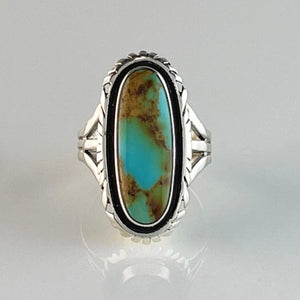 Get your hands on this stunning Vintage Ring. It’s has an exquisite Turquoise stone, you won’t want to take your eyes of it.   Made by Navajo artist Alfred Joe, this ring is set in Sterling silver with stunning Pilot Mountain turquoise. The oval cut stone is set in a smooth sterling bezel and accented with a cut and notched edge. Stamped