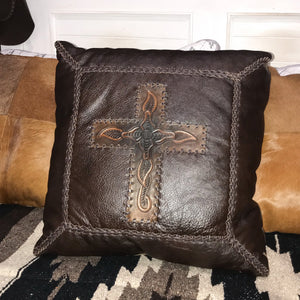 Country luxe furnishings   Add a touch of leather luxe to your homes interior with this Lexington Cushion. This cushion is all Western with its dark chocolate leather, embossed motif cross centre piece and buck-stitch detail.  Generous 18"x18". Pillow is crafted from 100% leather, filled cushion.  Dry clean only. Sourced by us from Dallas TX. Handcrafted in Mexico