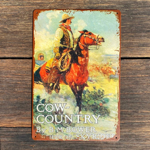 Tin Wall Art.   How cool is this! ‘Cow-Country’ by B.M Bower.  Distressed Wall Art. Perfect for any room, stables or business.  Size 20x30cm with four corner small screws holes ready for the wall or plaque.   This one is a harder to find! Collectable novelty.