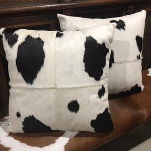Cowhide adds an element of individuality to your interior. It goes well with other natural materials but can also be mixed with industrial elements such as exposed brick and metals for an entirely modern style.  Black and White cowhide cushion set. Stitched 4 panels of cowhide with soft black suede backing and zip fastening.  The pair 2x filled cushions.  Aussie echo inner. Nice size 47 x 47cm.