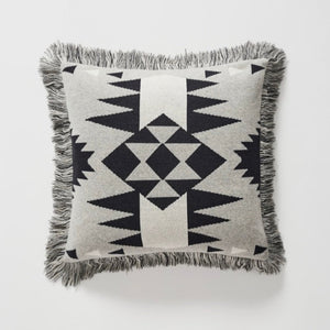 These versatile cushions can be used to warm up a room, add glamour, colour and texture or simply provide the finishing touch to any space.  This throw cushion features Navajo-inspired geometric motif and fringed edge. Modern colours of silver-grey, black and white accent.  Measurement: 45x45 plus fringe  Material: Face: Woven Cotton/Acrylic blend. Polyester Filled cushion.  As seen styled in Western Magazines.