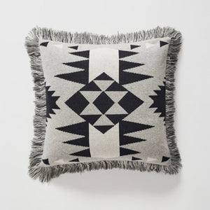These versatile cushions can be used to warm up a room, add glamour, colour and texture or simply provide the finishing touch to any space.  This throw cushion features Navajo-inspired geometric motif and fringed edge. Modern colours of silver-grey, black and white accent.  Measurement: 45x45 plus fringe  Material: Face: Woven Cotton/Acrylic blend. Polyester Filled cushion.  As seen styled in Western Magazines.