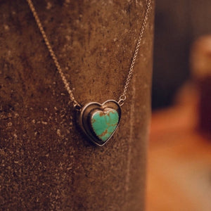 Exquisite hand-carved Kingman cabochon, Arizona Turquoise with a full matrix of vivid teal green-blue and rich copper accents. Vintage piece. Stone size 22mm.  Pendant size 1.25". Set in pure .925 sterling silver patina finish on SS chain 16.5" total length.  Designer pendant. Handmade in New Mexico. Smooth silver back, stamped.