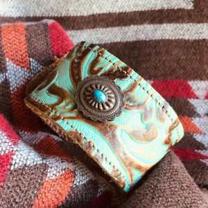 Vintage Western  Embossed leather cuff with Southwest Concho   Handmade. Two layers of leather have been expertly stitched together. The inside leather is soft on your wrist.  The fit: cuffs are approx 8 1/2 inches end to end with button and eye closure. There are two slots for different fits. 