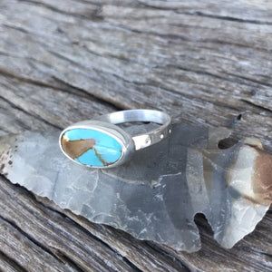 The Stone: A natural Royston Ribbon Turquoise gem with a full matrix of teal blue, azure and natural undertones.  The Ring: Natural oval shape in .925 silver with comfortable - elegantly simple silver band.  Artisan crafted in Australian using quality USA/Arizona Turquoise. ‘One of a kind’  Highly polished stone and silver. Stunning!