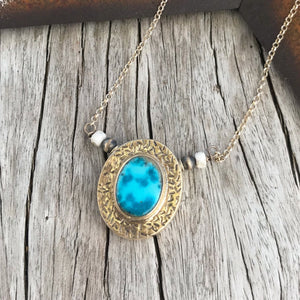 Nevada Turquoise 〰️ Exquisite 100% natural Nevada Blue Moon mine Turquoise set in .925 sterling silver pendant. Bead/Pendant size 1.5".  Stone size 11x13mm. Strung on a sterling silver chain with White Buffalo Turquoise and Navajo pearl accent on either side. 17". Handcrafted by silver makers in New Mexico 