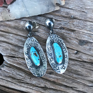 The Stones. Gorgeous natural sky blue Kingman mined Turquoise. Hand cut stone size 8x10mm.  Style: set in decorative southwestern style .925 sterling silver hand stamped earrings! 2" in length overall with vintage sterling clasps. Handmade in the heart of New Mexico