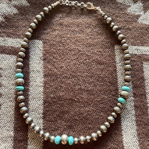 Desperado Collection.   16” strand of 6, 8 and 10mm Navajo Pearls with Arizona Turquoise Rondelles. Midi length sits beautifully between your collarbone, perfect with your favourite shirt or western attire. The clasp comes with a 1" extension chain so you can play with the length.