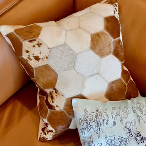 On Trend Textile, be the envy of your friends with this gorgeous throw cushion.  Front of cushion features cowhide ‘honeycomb patchwork’ design with dark brown leatherette backing. Stuffed cushion.  Each cushion is unique. Nice big 46cm x 46cm.
