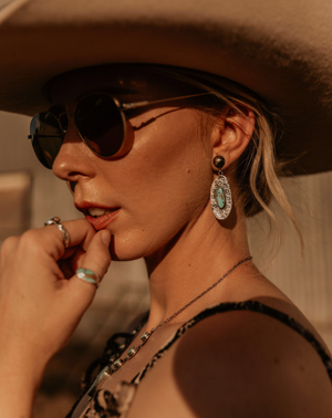 Gorgeous natural sky blue mined Kingman Turquoise. Hand cut stone size 8x10mm, set in southwestern style .925 sterling silver hand stamped detail ‘stamped’ earrings! 2" in length overall with sterling clasps. @Roxywestau available @swancreekinteriors Australia