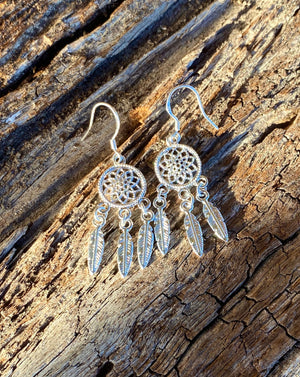 These Navajo inspired earrings are gorgous with their dangling feather charms.  Artisan made in .925 Sterling silver. 