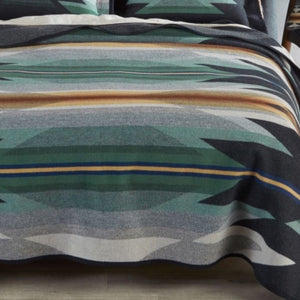 Add tranquility and style to your bedroom with the stunning Wyeth Trail Collection.   This blanket design reflects the warm, harmonious colors of ancient corn varieties, in a balanced pattern of rows that echo long-ago gardens. Arrows point in two directions: the past and the future.  Fully reversible for two different seasonal looks.