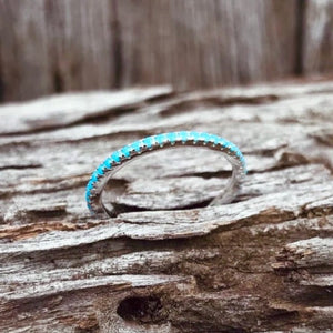 Dazzling Turquoise Stackers.   Sparkling beauties, these petite stacker rings look gorgeous on any finger.   Full band of bright blue Turquoise stones. Made in .925 silver.   Gift boxed.  See our ring guide for size. RRP $29.
