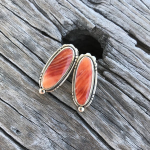 Then stones: Show Stoppers! Beautiful natural light red/ orange Spiny Oyster with natural matrix from the coast of Baja. Shell size oval 20x8mm. Highly polished genuine beauties.  The setting: Artisan made in pure .925 sterling silver with Southwest style accents! Overall earring length, just shy of 1".