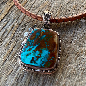 This large vintage pendant is stunning and even better in person.  * Pendant ~ Royston Turquoise with intriguing rich blues and copper brown matrix. {Nevada} Cabochon is set in handcrafted .925 sterling silver decorative pendant and bail.  Overall this pendant measures 1.75" ~ 27x24mm stonesize. One of a kind!  Vintage Pre 2000