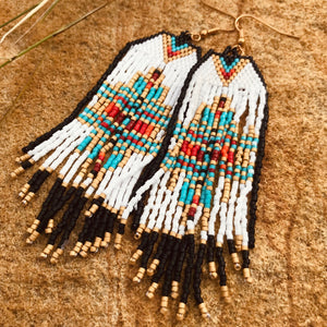 You’ll be the envy of you besties in these Navajo inspired earrings.  Artisan made. This hand-beaded design is simply stunning. Dramatic size.  Southwest hues, black, white, turquoise, tan and red with golden accent.