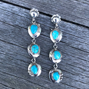 The Stones. Gorgeous 100% natural turquoise in sky blue with golden tan matrix from the Sierra Nevadas. These 3 tier/stone drop beauties are set in handcrafted polished sterling silver.  Sky blue 100% natural turquoise! Stamped .925 sterling silver, artisan crafted in New Mexico. Full 2.5" in length with hand-formed sunburst post studs. RRP $475