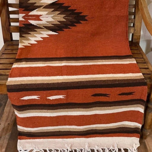 The blend of beautiful rustic red adobe hue and southwestern design are sure to enhance your living space.  The Adobe Rug Blanket, is bigger amd firmer than our diamond blankets.   It can be styled many ways. Lay it over the bed or patio furniture, use as an accent floor rug, wall tapestry or take it on your weekend camping adventure.   Extra Large: 5x7’ = 155cm x 215cm approx.  Made in Mexico from handwoven fine acrylic blend. Durable medium weight. Fringe ends.