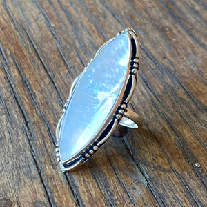 You'll be in love with this iridescent ✦MOP✦ dress ring. Artisan made in .925 Sterling silver, elongated Southwest design covers the top of you finger.  Weight : 8.77 Gram Approx ✦Stone Size : 40 x 13 MM Approx.