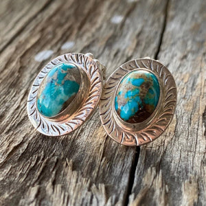 The Stones. Gorgeous 100% AA natural turquoise in aqua blue with golden tan matrix from the Sierra Nevadas. Stone/ cabochon size 18x15mm each.  Stamped .925 sterling silver, artisan crafted in New Mexico. This incredible pair of earrings - medium in size measure .75" in length including the sterling silver etched setting. Post studs with artisan backs.