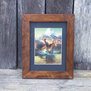 Print from Sid Richardson Museum collected on our travels around Fort Worth TX. This iconic Western painting is’Trouble on Pony Express’ by Frank Tenney Johnson originally painted around 1910.     Small print on card framed with Swan Creek’s signature wooden frame. Slightly fancier yet retains the lustrous rustic character of native Australian timber. Framed size W17 x H22cm