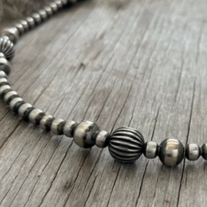 This gorgous design is the 24” long strand of 5, 6 and 8mm Navajo Pearls with southwest pumpkins beads.   Stunning long length. The clasp comes with a 1" extension chain so you can play with the length.