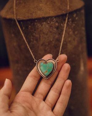 Exquisite hand-carved Kingman cabochon, Arizona Turquoise with a full matrix of vivid teal green-blue and rich copper accents. Vintage piece. Stone size 22mm.  Pendant size 1.25". Set in pure .925 sterling silver patina finish on SS chain 16.5" total length.  Designer pendant. Handmade in New Mexico. Smooth silver back, stamped.