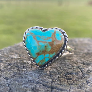 Get your hands on this stunning Navajo Ring. It’s has an exquisite Turquoise stone, you won’t want to take your eyes of it.   This adorable heart ring was made by Navajo artist Alfred Joe and is set with # 8 turquoise. The heart cut stone is set in a smooth sterling bezel and accented with sterling twist rope. Stamped.  Size of Setting: 3/4” by 3/4 ”Heirloom item.  One of a kind collectors item to be worn, admired and treasured.   Size AUS P-Q. 8 3/4 (Medium-Large) see our ring guide. 