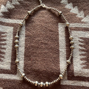 Espuela, the ‘Rock n Roll’ of Navajo Pearls!   Iconic Western design, 4, 5, & bigger 10mm Navajo Pearls creates this dramatic look. Lovely long 20” inches, these long strands can be worn numerous ways to create your desired look. The clasp comes with a 1" extension chain so you can play with the length.