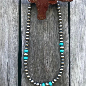 Desperado Collection. 16” strand of 6, 8 and 10mm Navajo Pearls with Arizona Turquoise Rondelles.   Midi length sits beautifully between your collarbone, perfect with your favourite shirt or western attire. The clasp comes with a 1" extension chain so you can play with the length.